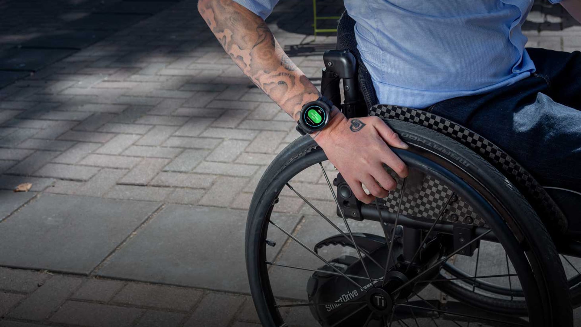 Smart Drive Push Tracker Lifestyle Shot - Showing wheelchair push rims