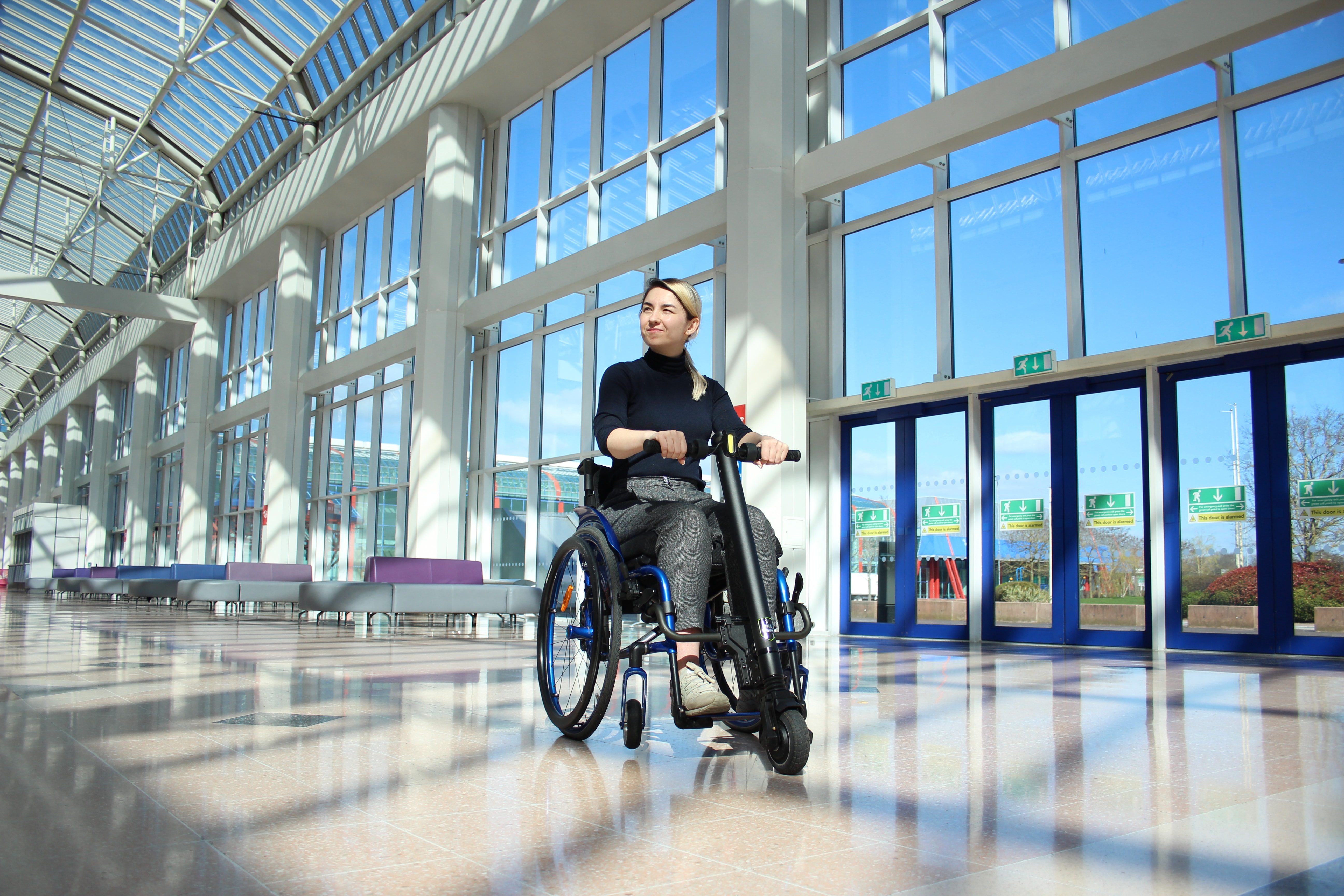 wheelchair user using the UNAwheel indoors